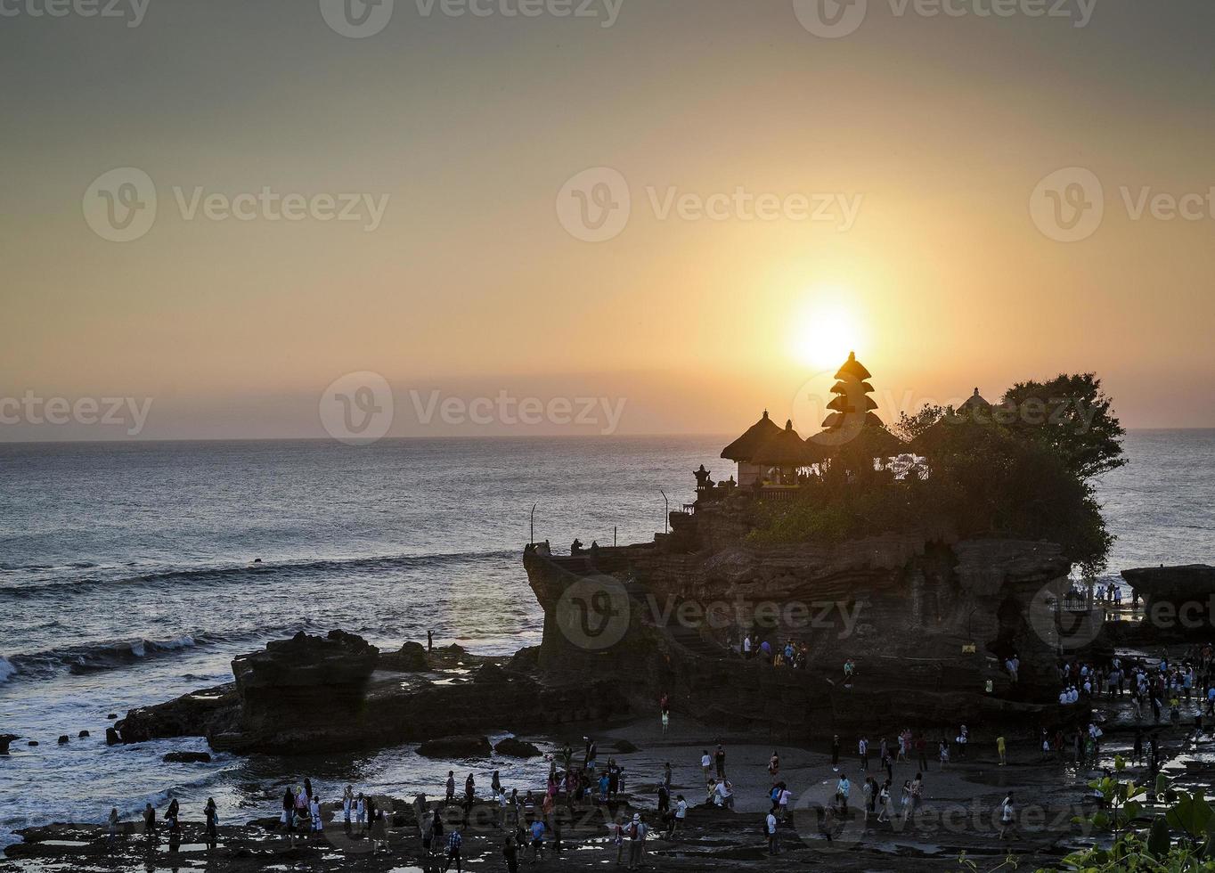 Pura Goa Lawah Hindu temple sunset backlight silhouette in Bali Indonesia photo