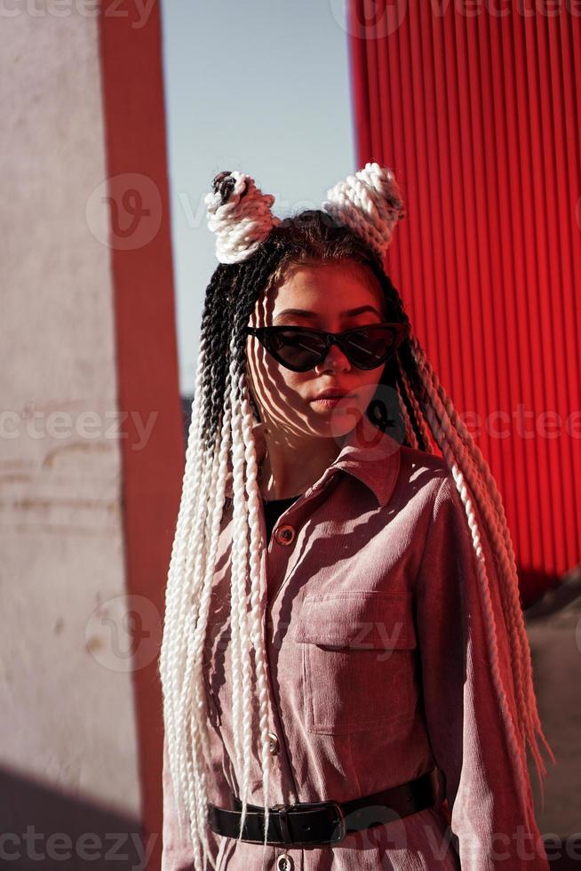 Portrait of beautiful cool girl over urban wall photo