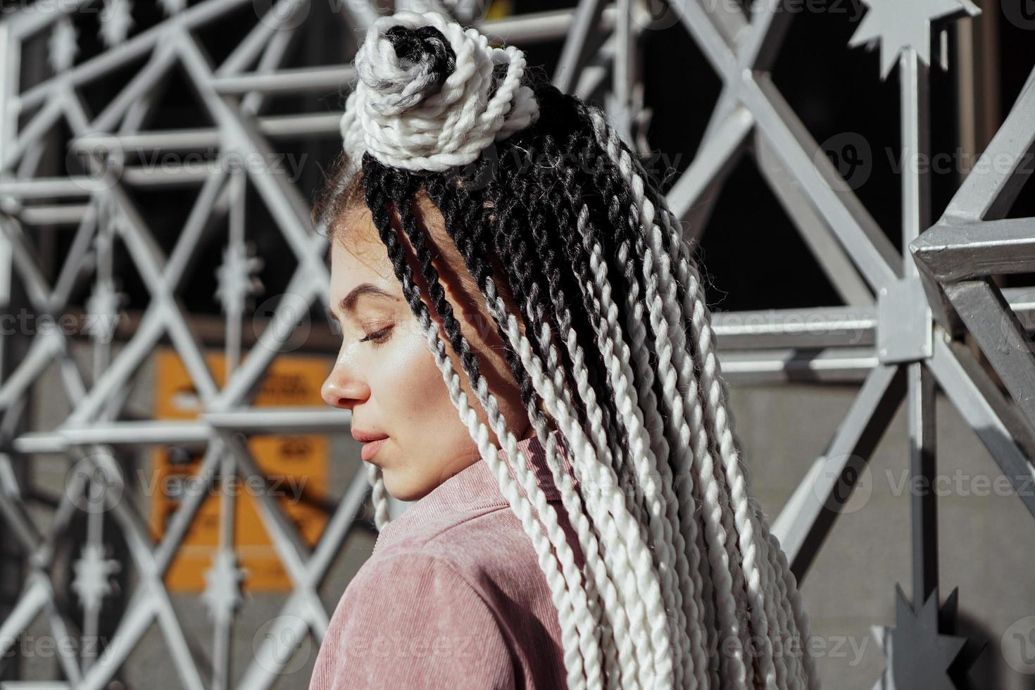 Young woman with futuristic looks. Girl with black and white pigtails photo