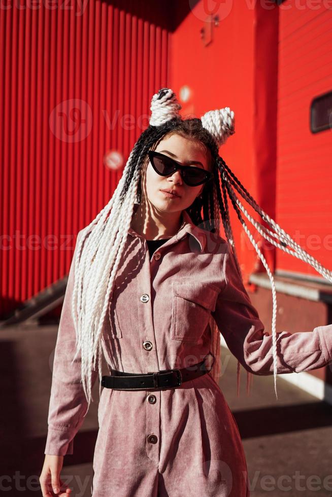 Portrait of beautiful cool girl over urban wall photo