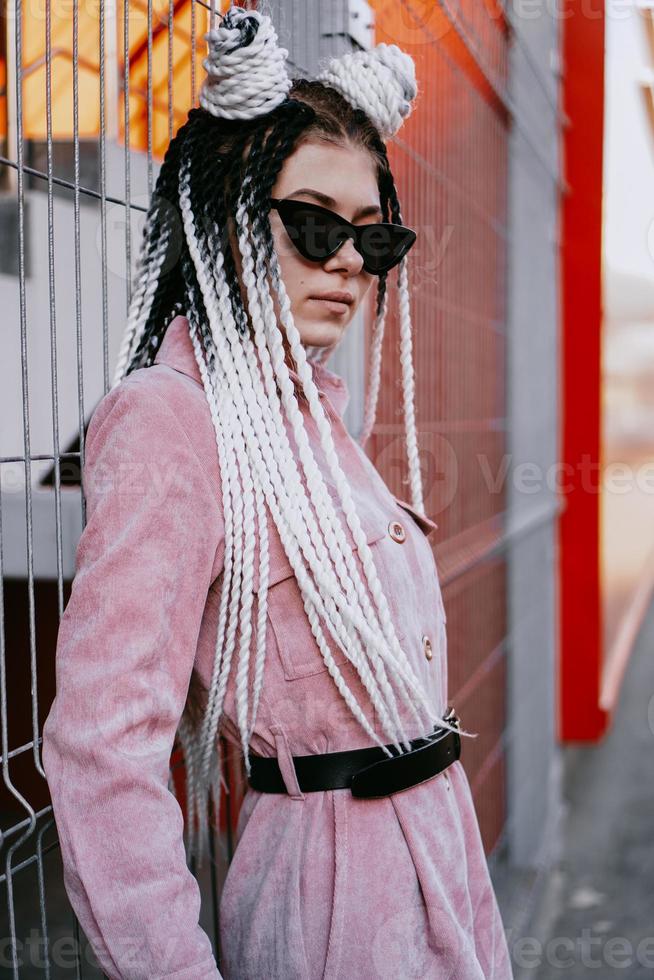 Portrait of beautiful cool girl over urban wall photo