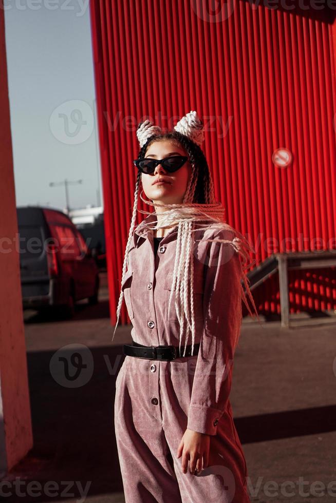 Portrait of beautiful cool girl over urban wall photo