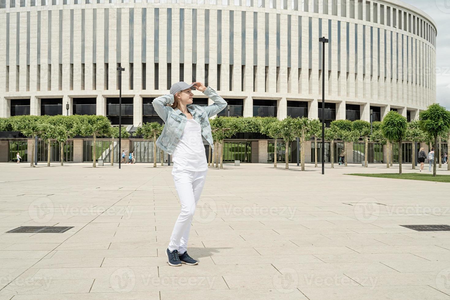 Happy young woman standing in the park photo