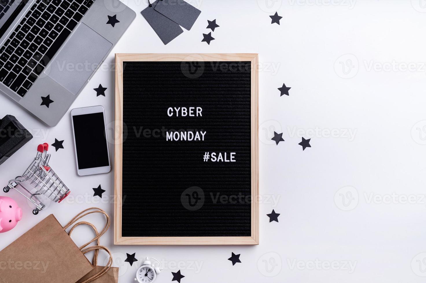 Text cyber monday sale on black letter board with laptop, smartphone, photo
