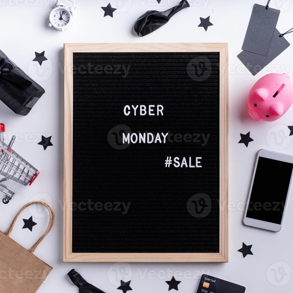 Text cyber monday sale on black letter board with laptop, smartphone, photo