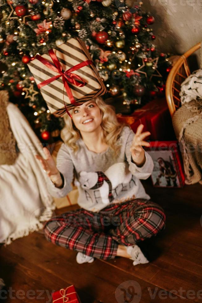 Woman throwing up a gift, concept of the new year, Christmas photo