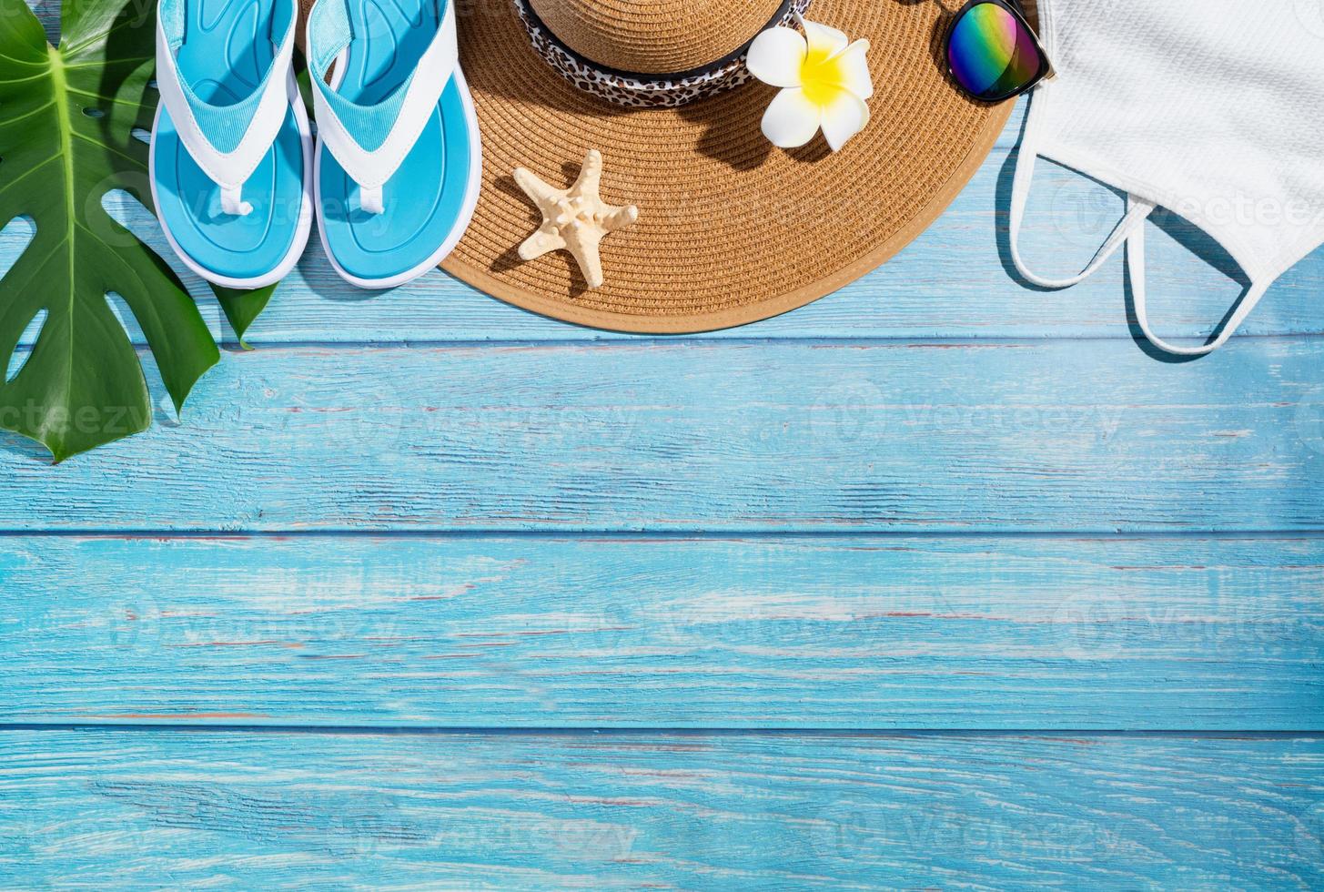 Summer accessories with clothes, shoes, tropical leaves and flowers photo