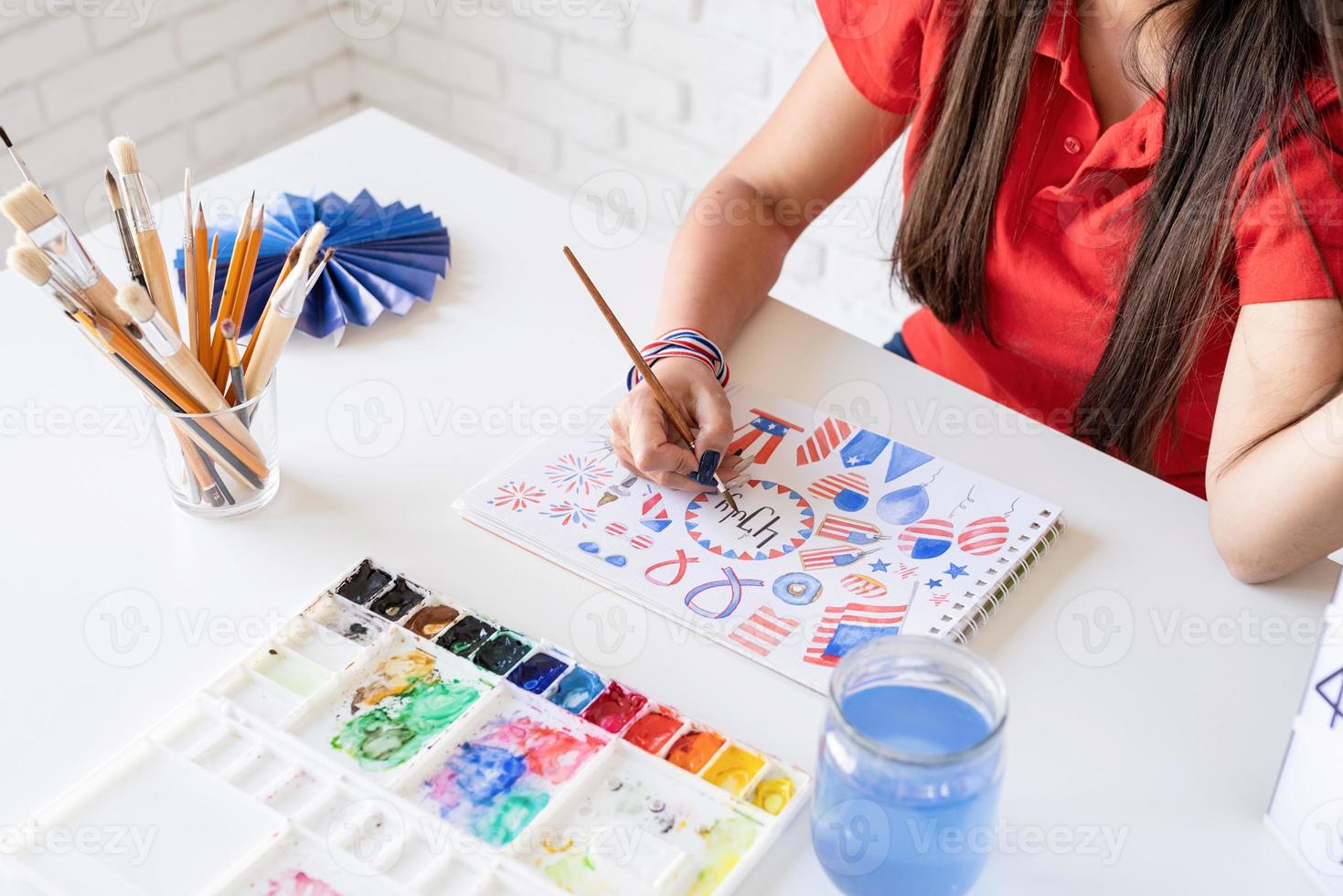 Woman drawing a watercolor illustration for Independence day of the US photo