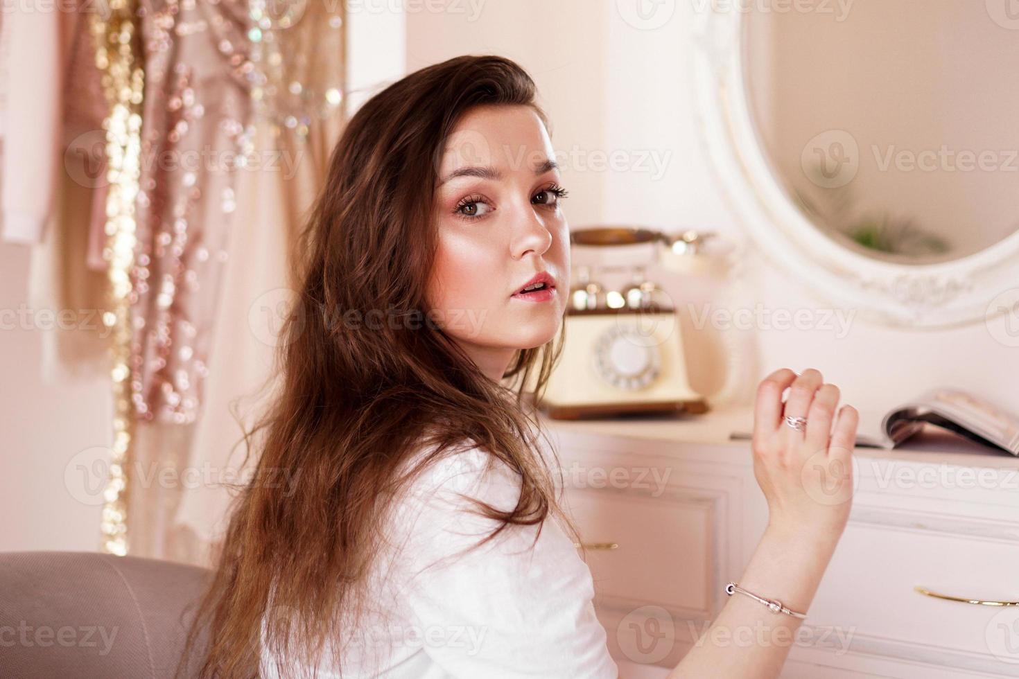 Happy woman in her room near her dressing table posing before party photo