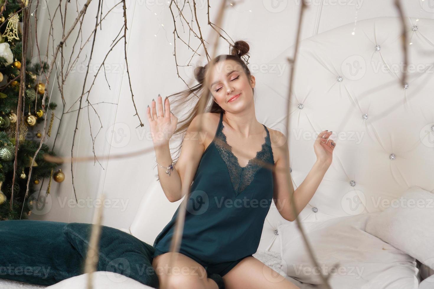 Girl in a peignoir. Beautiful sexy lady on the bed in her bedroom photo