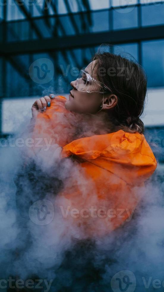 Girl in protective overalls and glasses. Air pollution concept photo