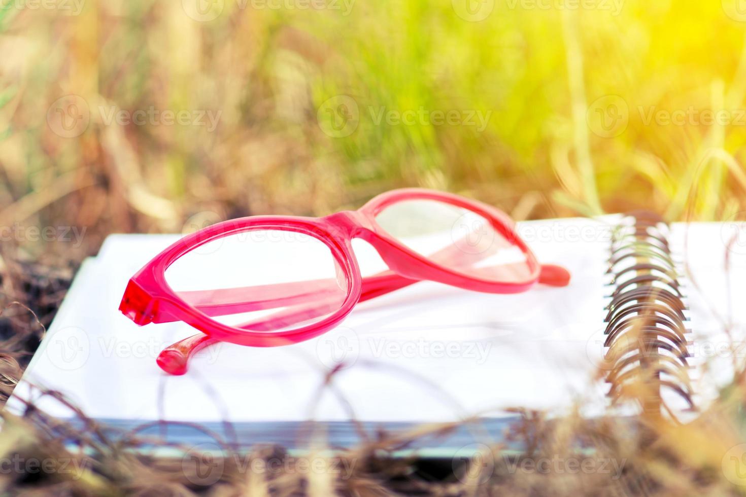 Red Glasses on Open Blank Notebook photo