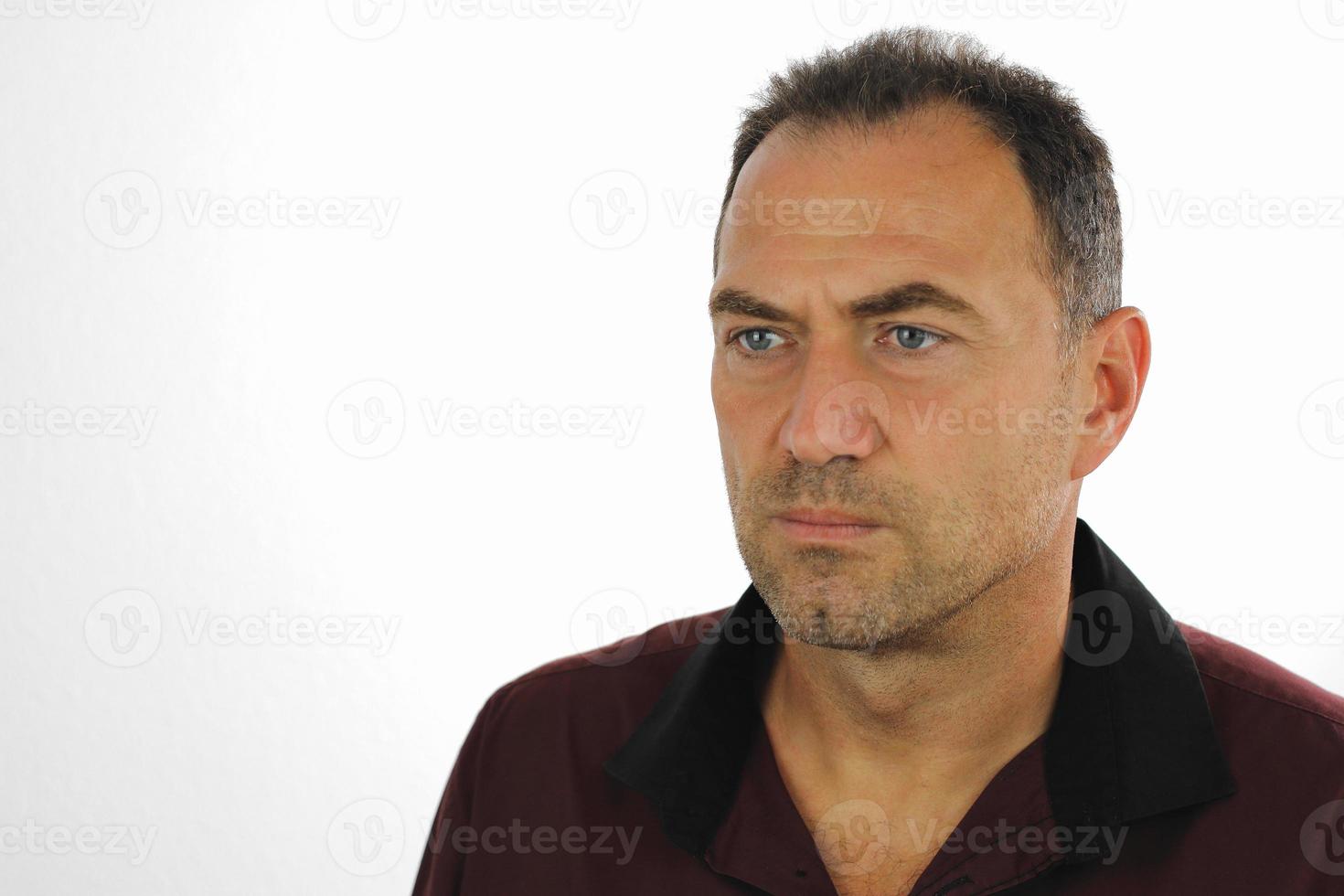 Man with serious look in dark shirt photo