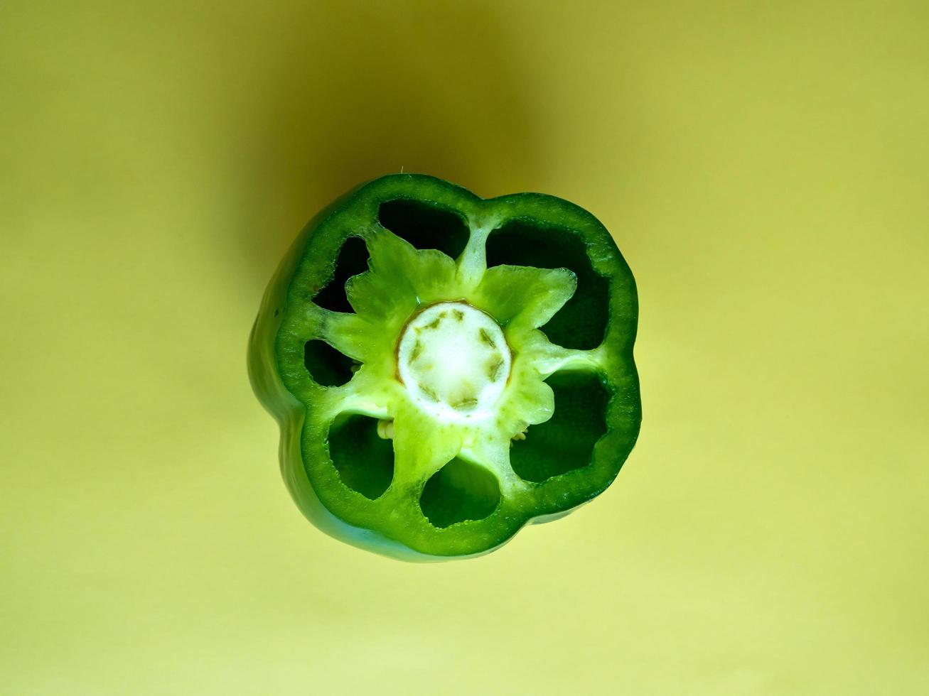 Green bell pepper on a green background photo