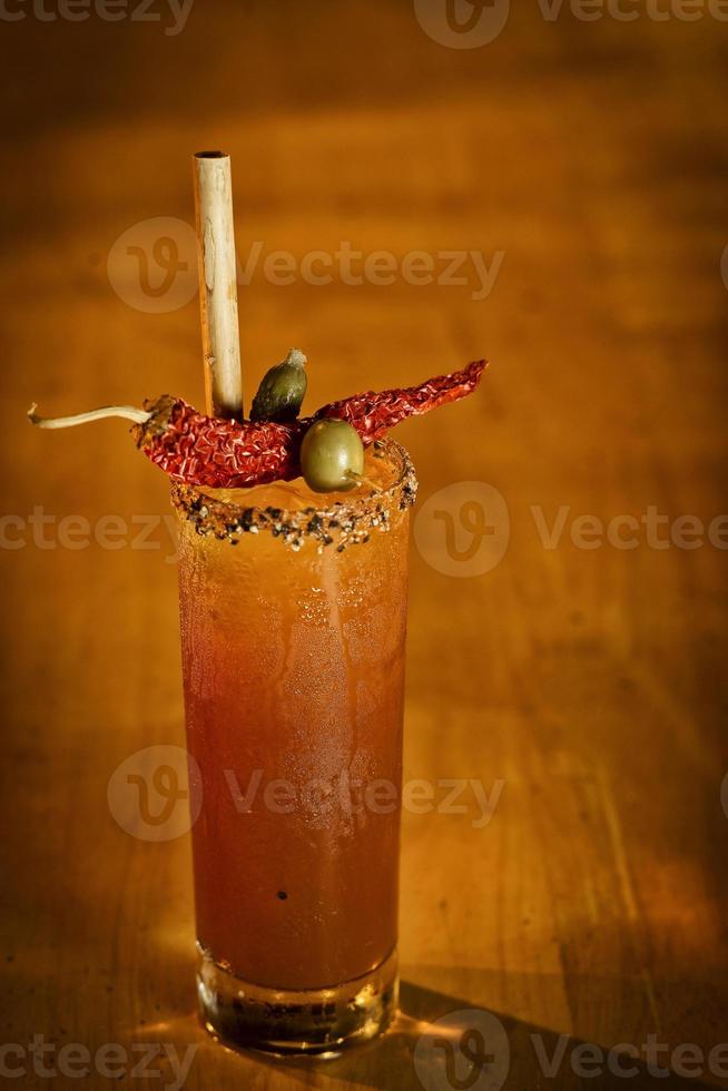 Spicy bloody mary tomato cocktail drink in modern bar photo