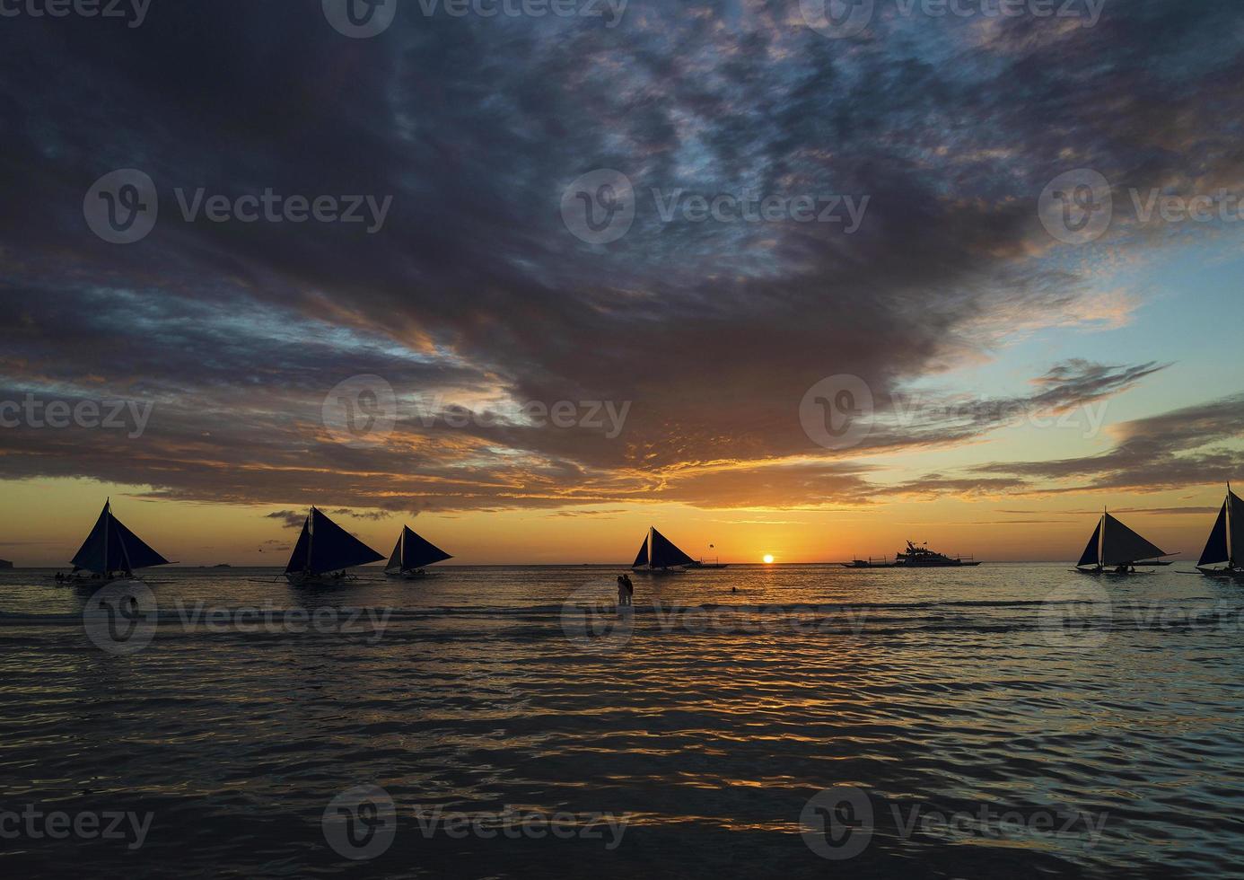 Sailing boats at sunset on Boracay tropical paradise island Philippines photo