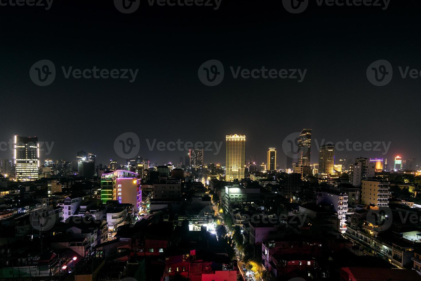 Urban view of central Phnom Penh city skyline in Cambodia at night photo