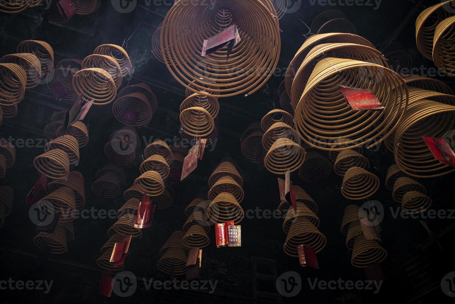 Traditional burning incense coils inside Chinese a-ma Buddhist temple in Macau China photo