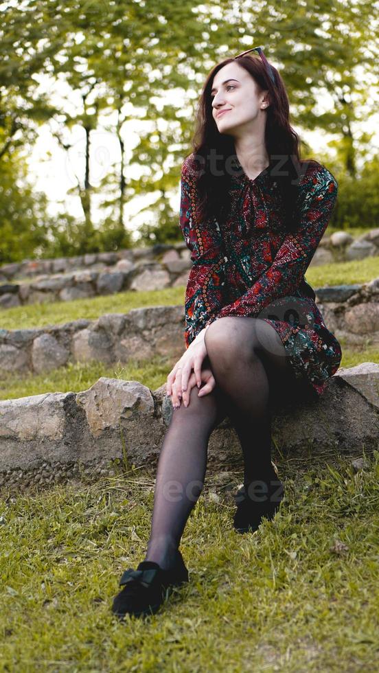 Attractive young woman enjoying her time outside in park photo