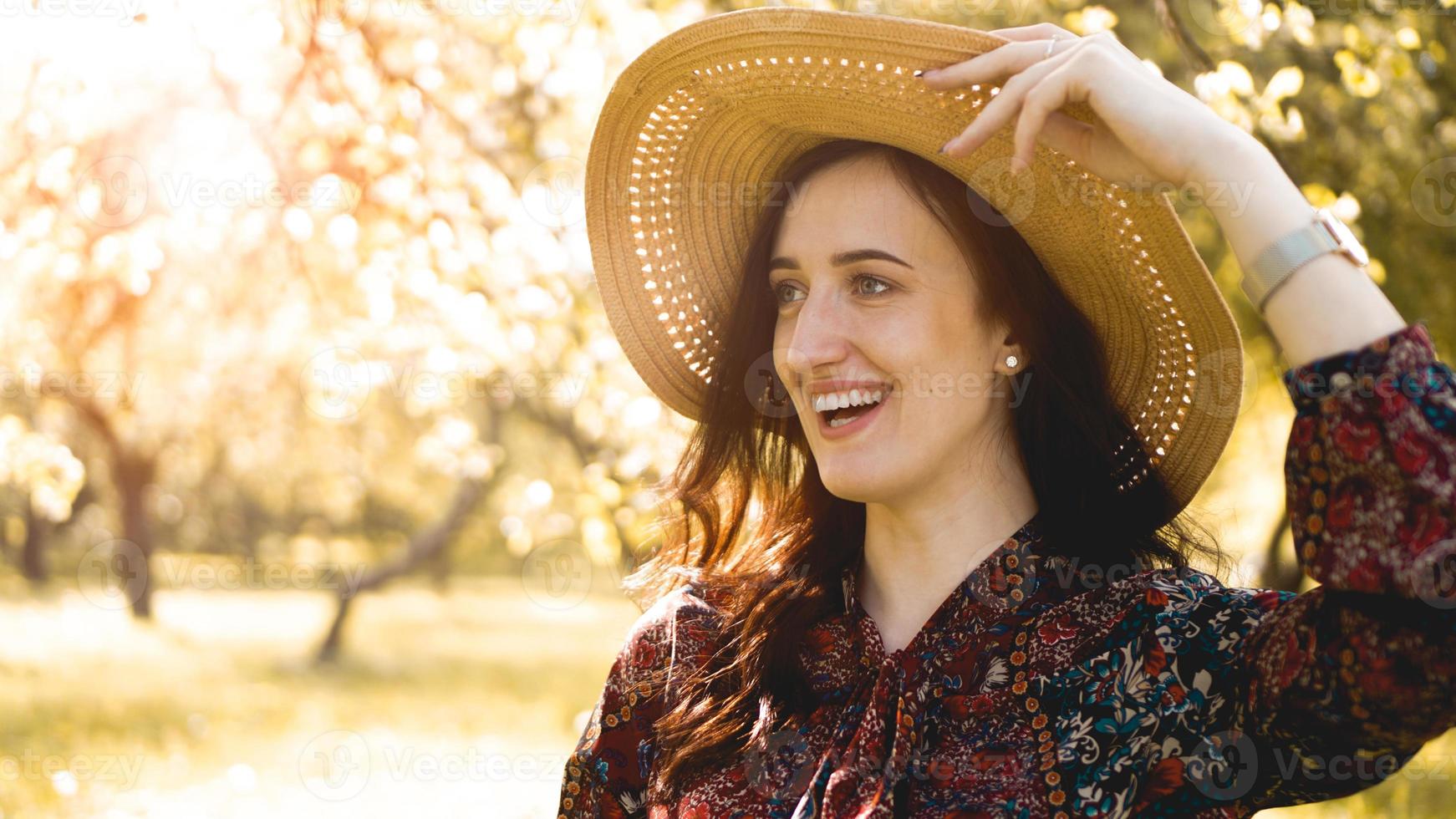 retrato, joven y bella mujer con sombrero de paja al atardecer foto