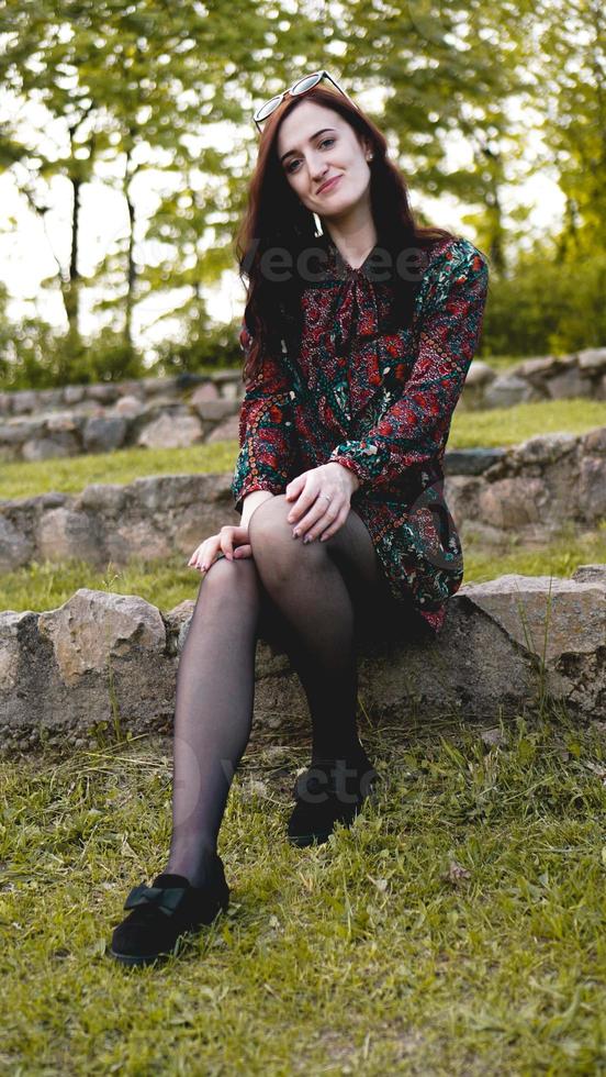 Attractive young woman enjoying her time outside in park photo