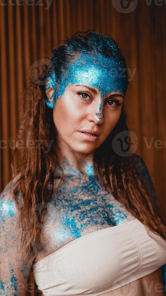 Woman with sparkles on her face. Girl in the bath photo
