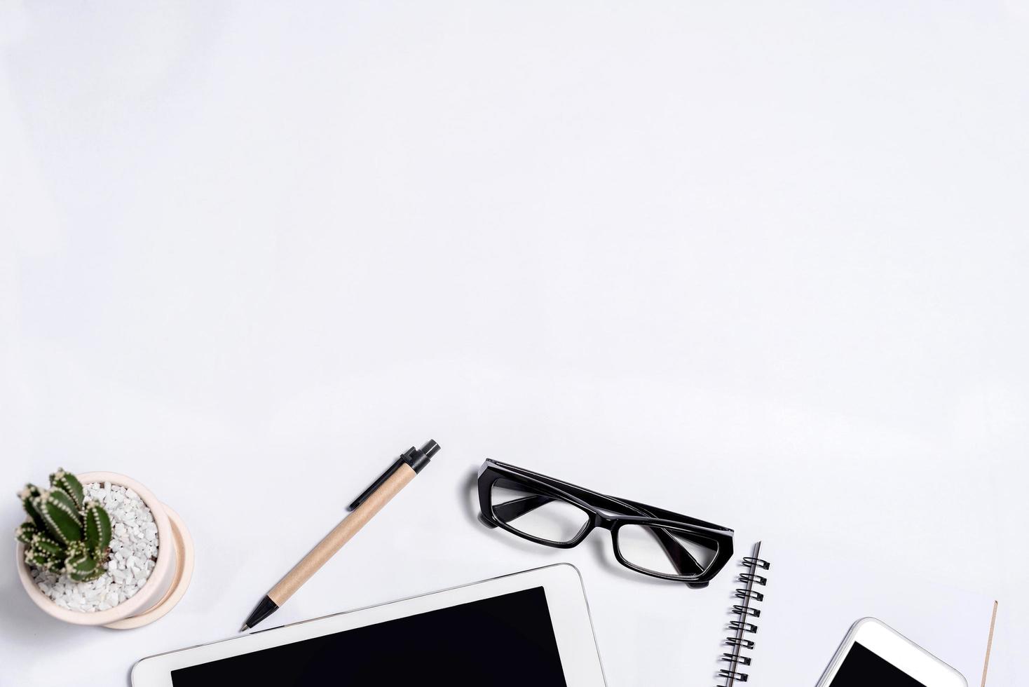 White office desk table with a lot of things on it photo