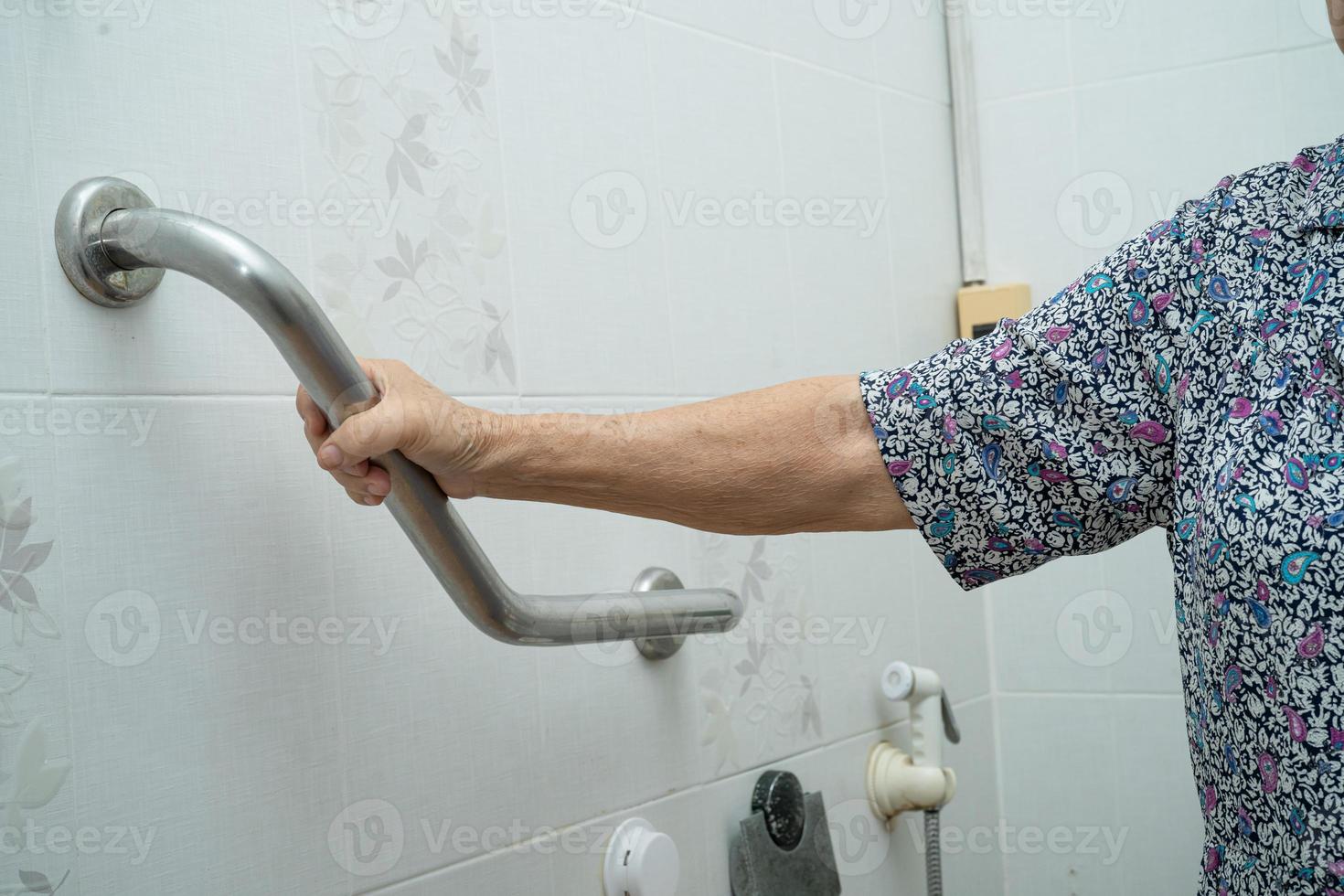 Asian senior woman patient use handle security in toilet photo