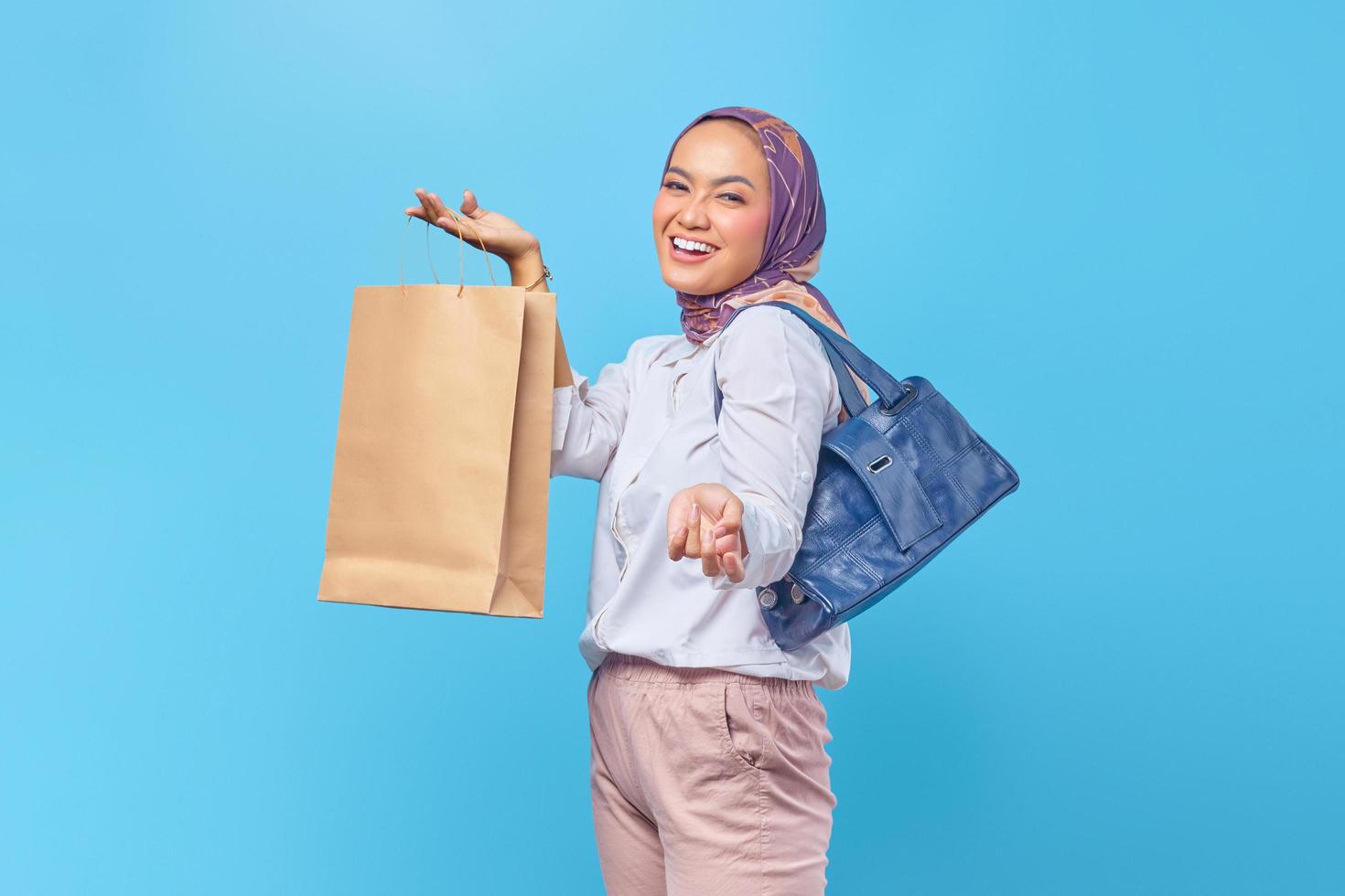 Portrait of happy young girl holding shopping bag photo