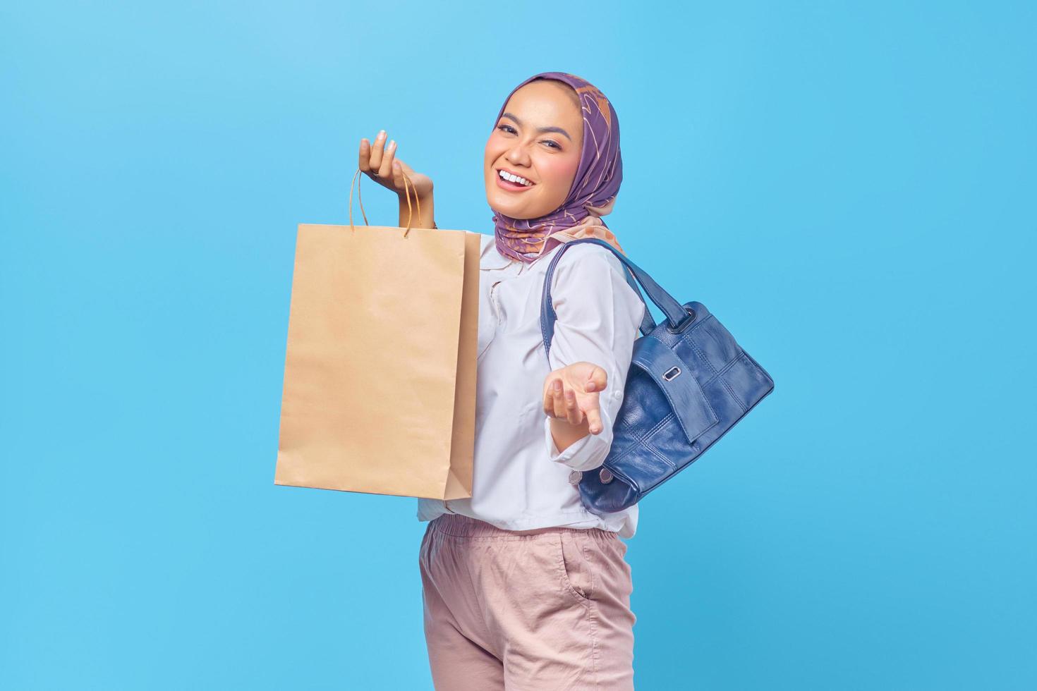 Portrait of happy young girl holding shopping bag photo