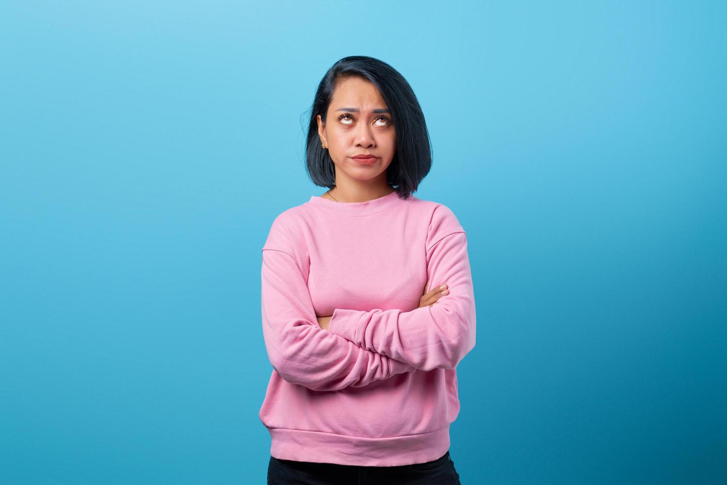 Portrait of beautiful young Asian woman with crossed arms photo