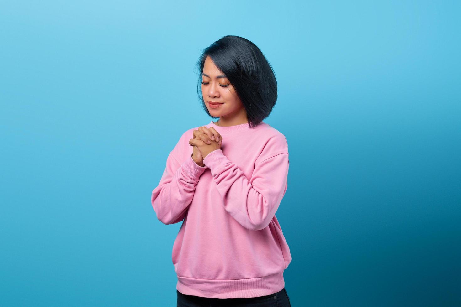 Portrait of beautiful Asian woman praying god ,believe in lord photo