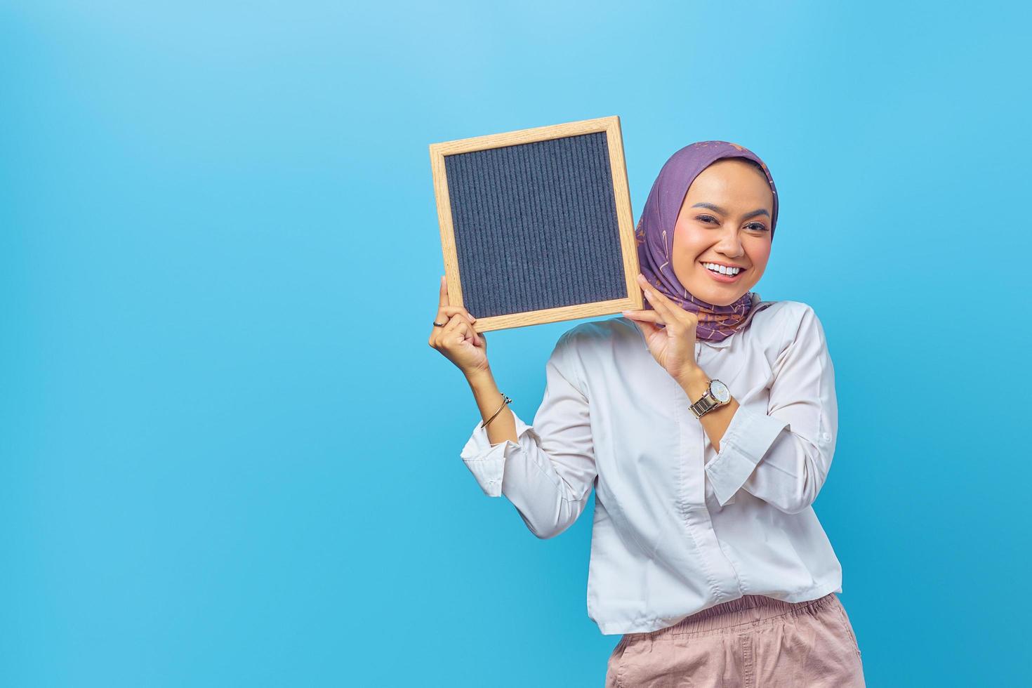 Portrait of Asian woman holding board with smiling expression photo