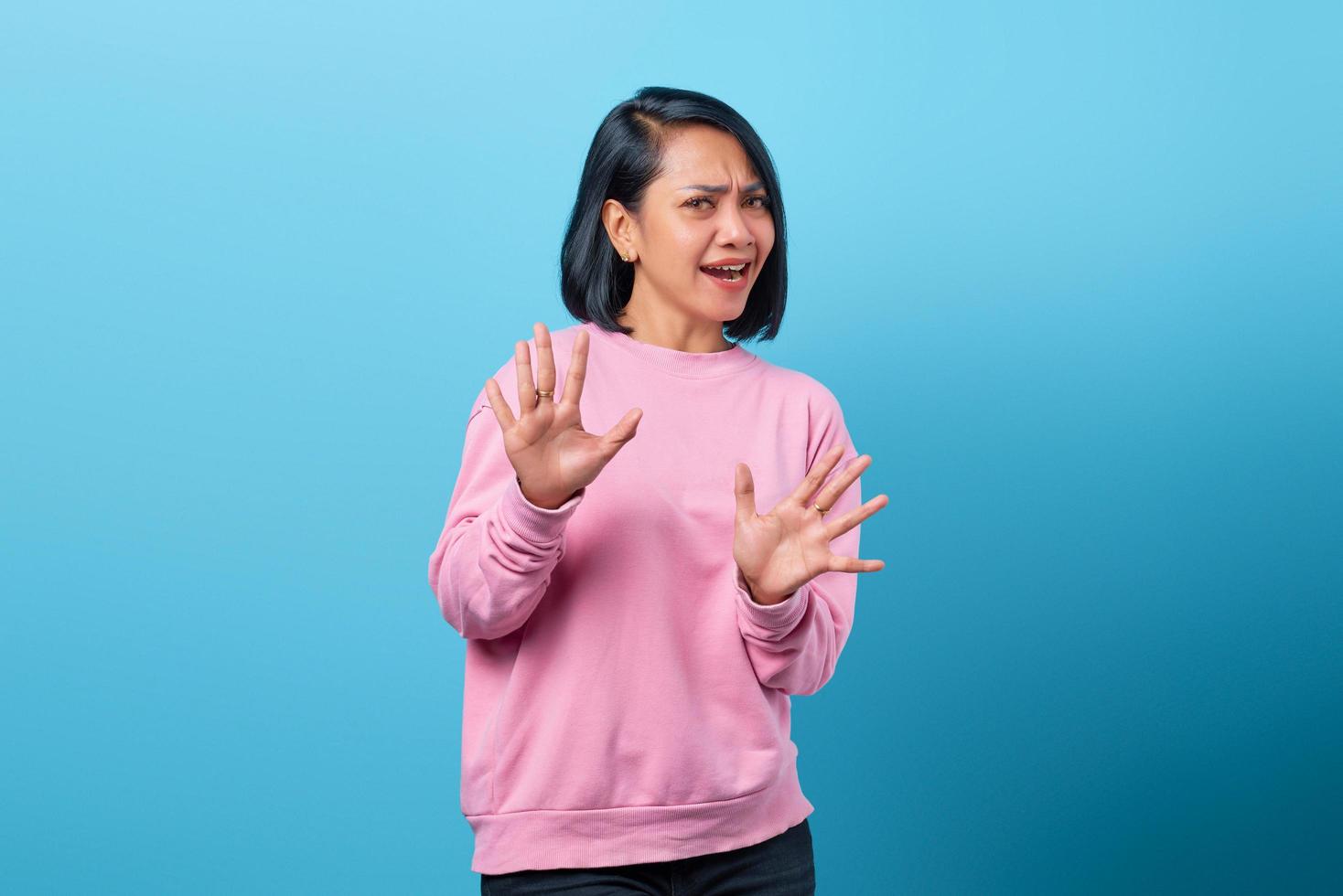 Portrait of beautiful young Asian woman refusing offer feeling awkward photo