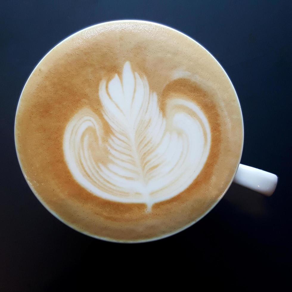 Top view of a mug of latte art coffee. photo