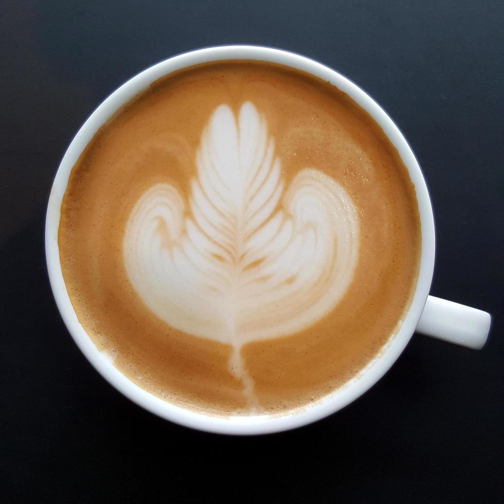 Top view of a mug of latte art coffee. photo