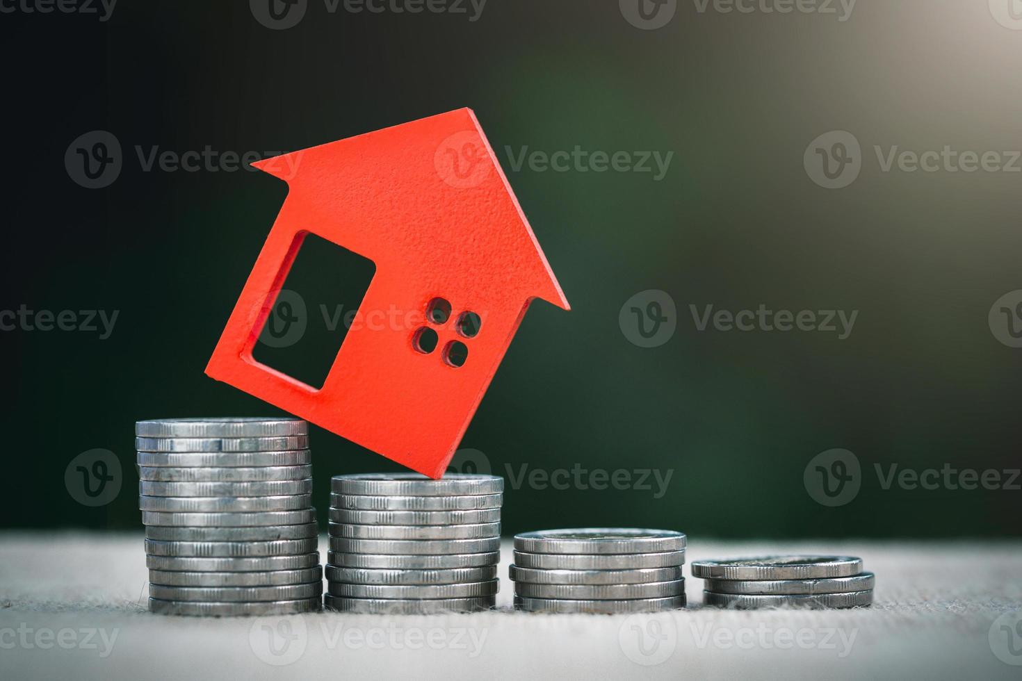 Miniature colorful house on stack coins, Finance and Investment concept and Real Estate Growth Interest. photo