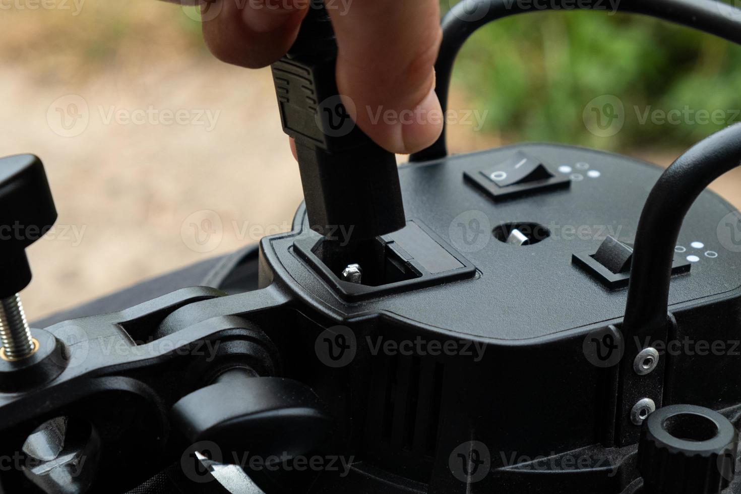 Insert the power cable into the electrical equipment. photo