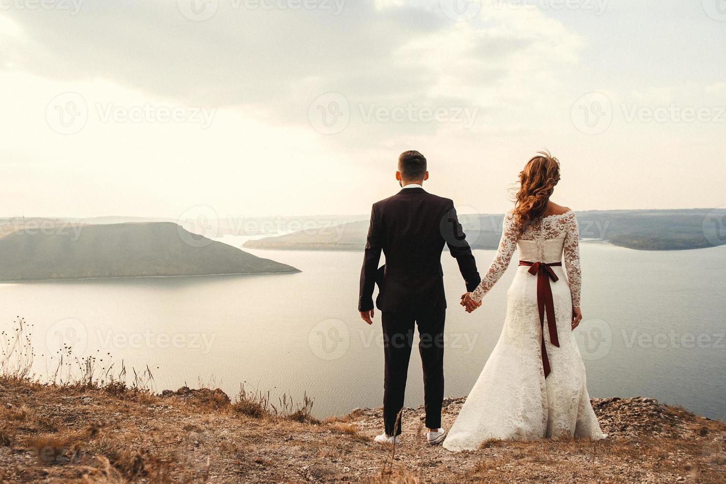 Married couple embracing on a mountain photo