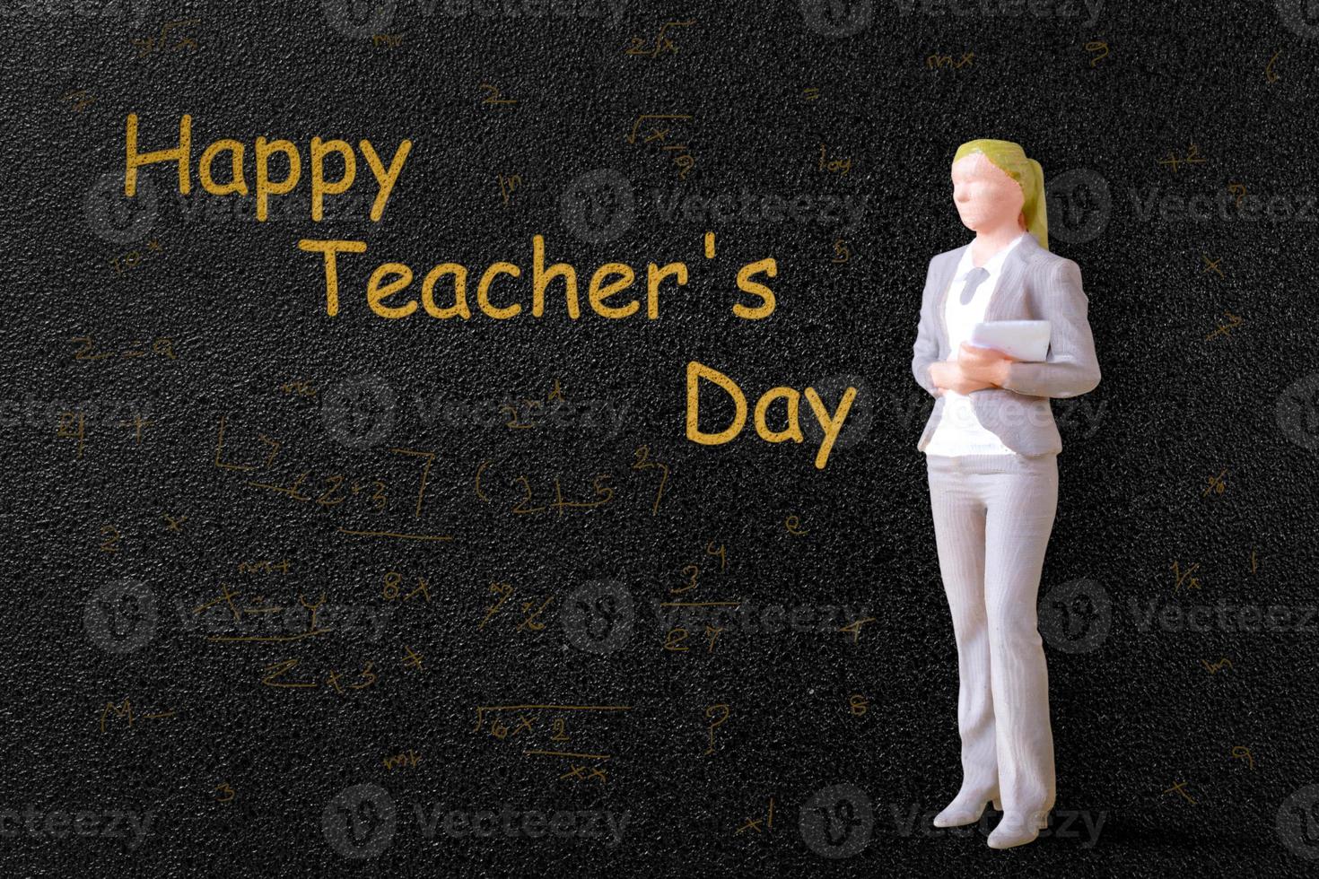 Miniature people Teacher in front of blackboard photo