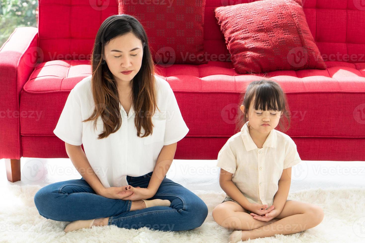 Mother and daughter meditating photo