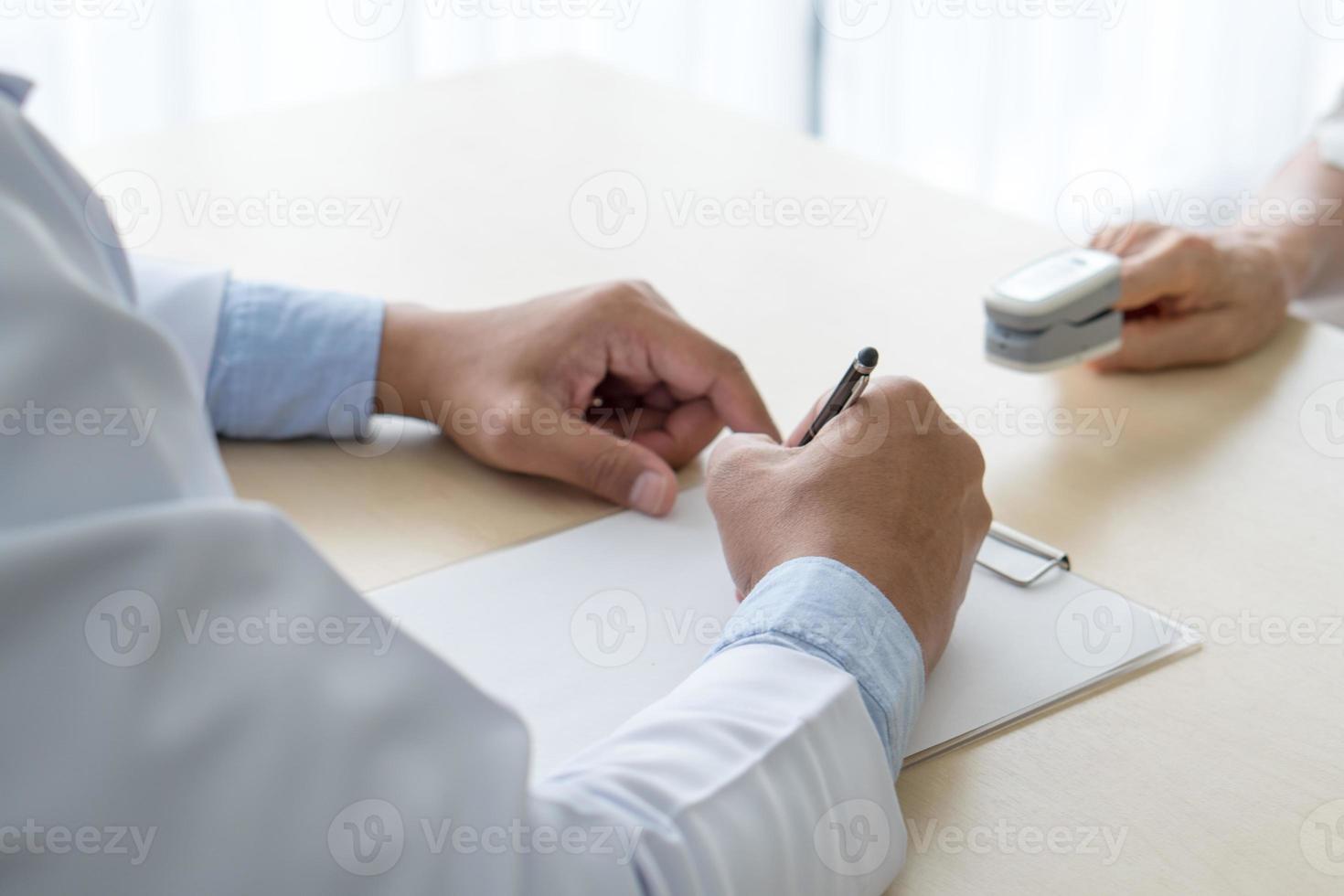 Doctor measuring oxygen saturation with pulse oximeter machine photo