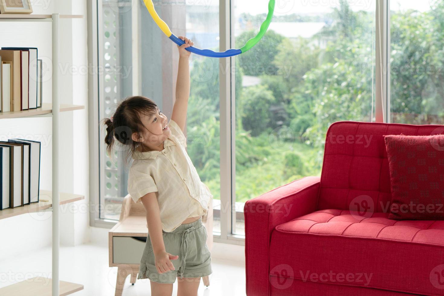 Little girl playing with a hula hoop photo