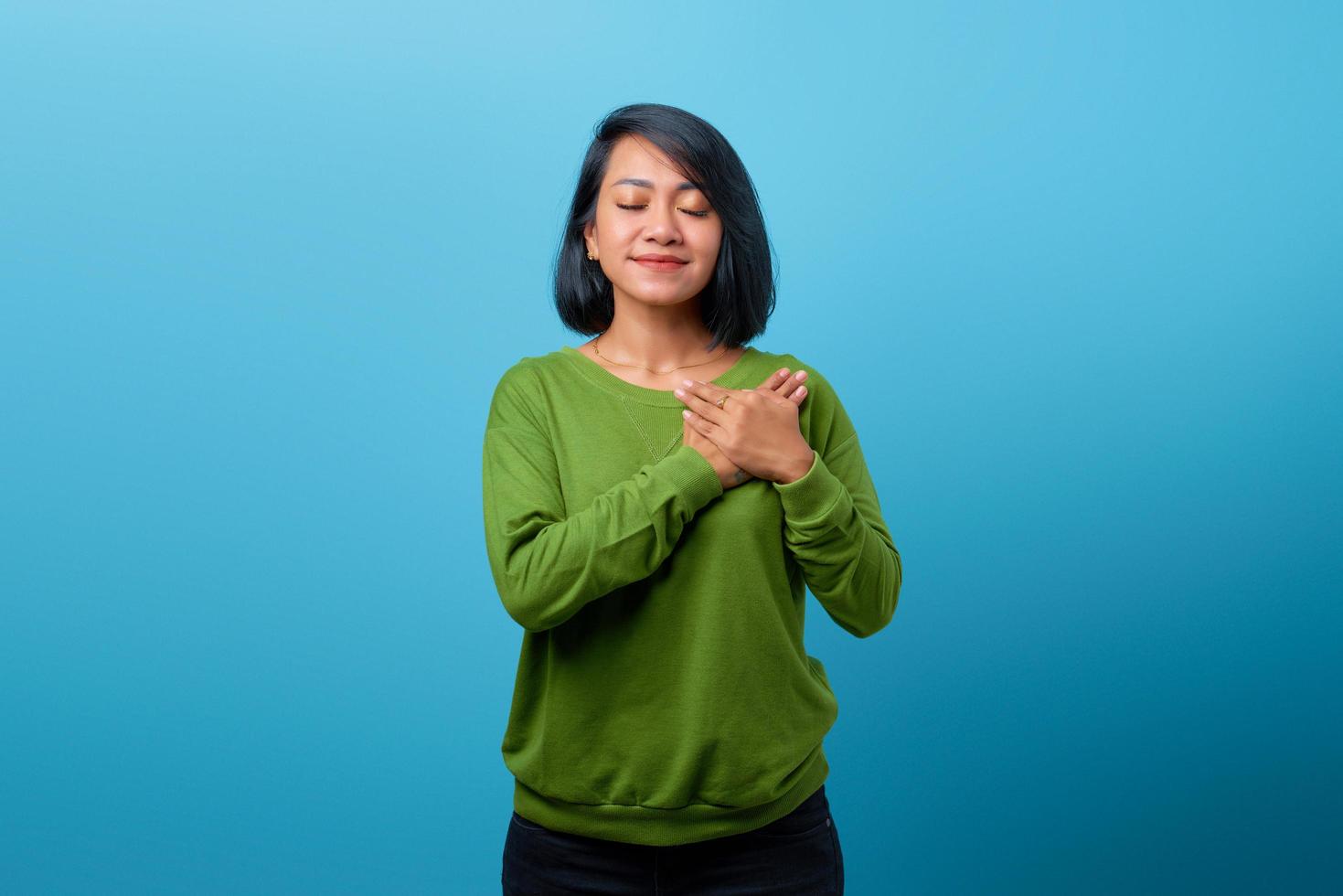 Beautiful Asian woman close eyes and smiling keeping memories in heart photo