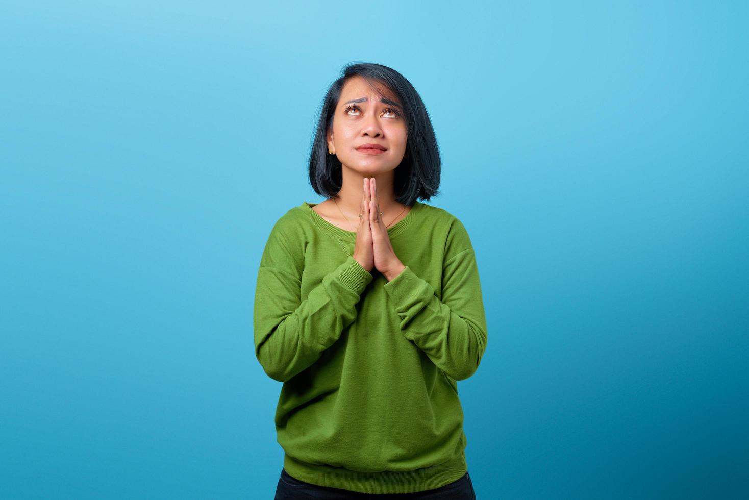 Attractive Asian woman praying with hope expression photo