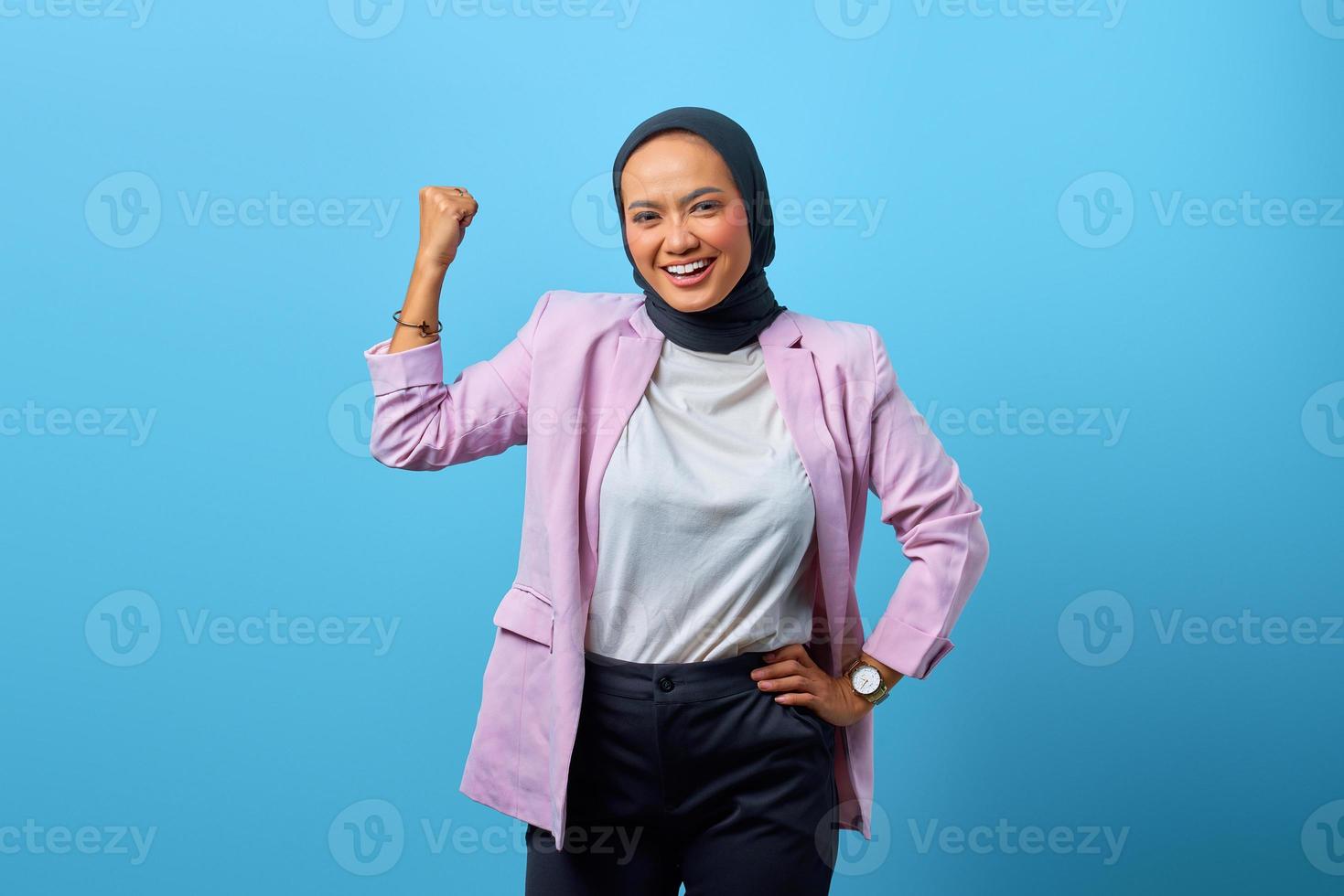 Portrait of attractive Asian woman demonstrates strong hand photo