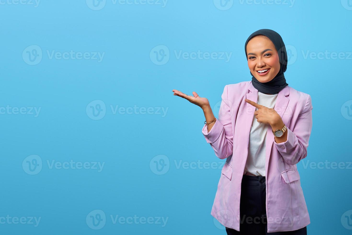 Cheerful Asian woman showing product photo
