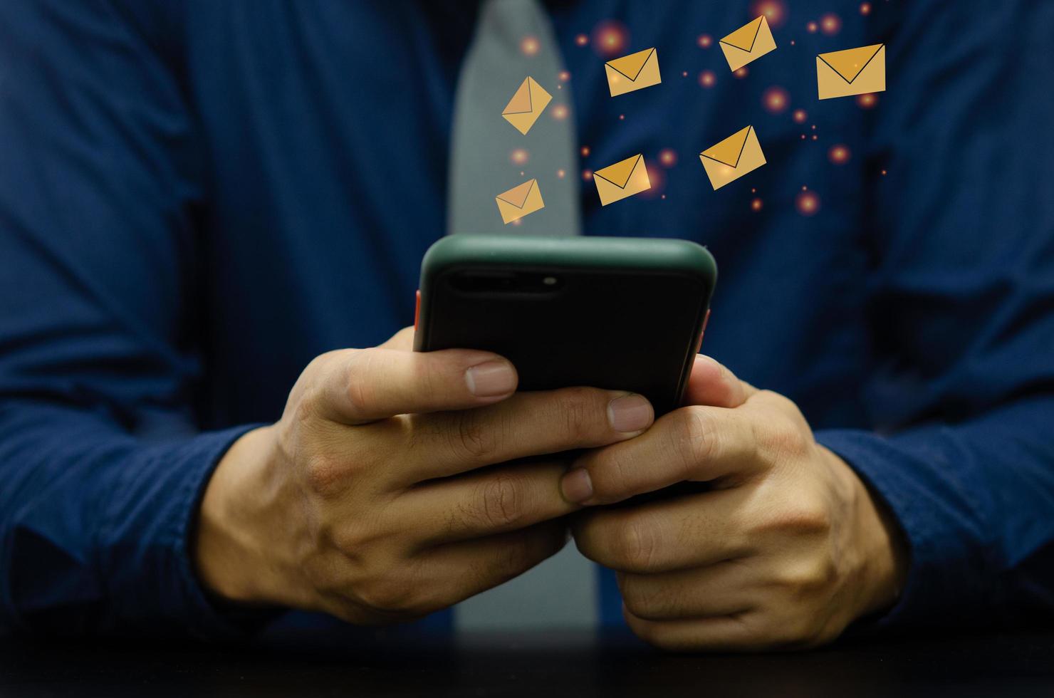 Man holding a cell phone an icon email message photo