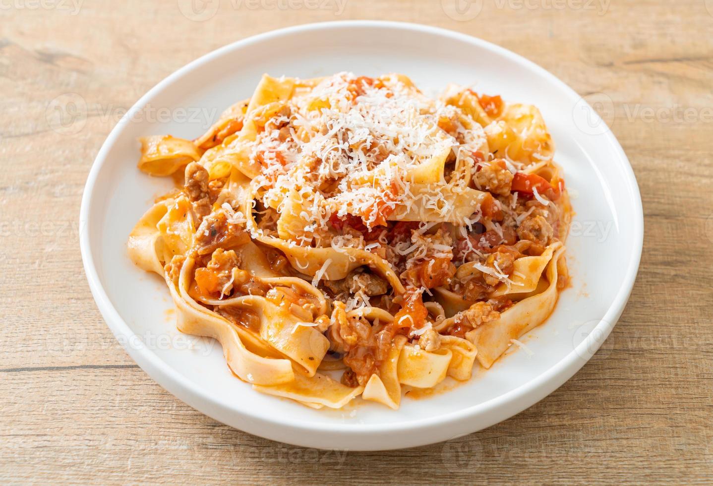 Homemade pasta fettuccine bolognese with cheese photo