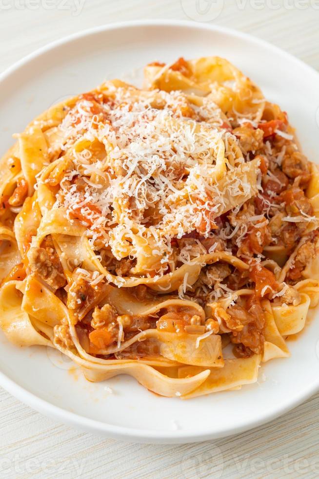 Homemade pasta fettuccine bolognese with cheese photo